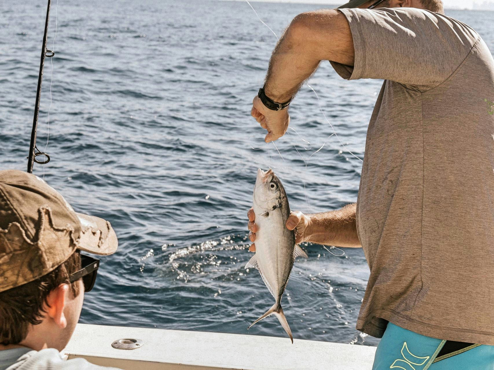 man fishing from boat
